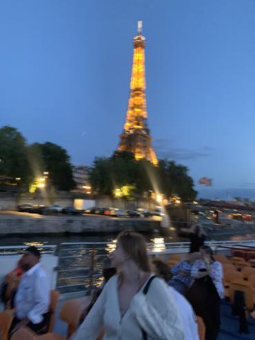 Blurry picture in front of Eiffel Tower.