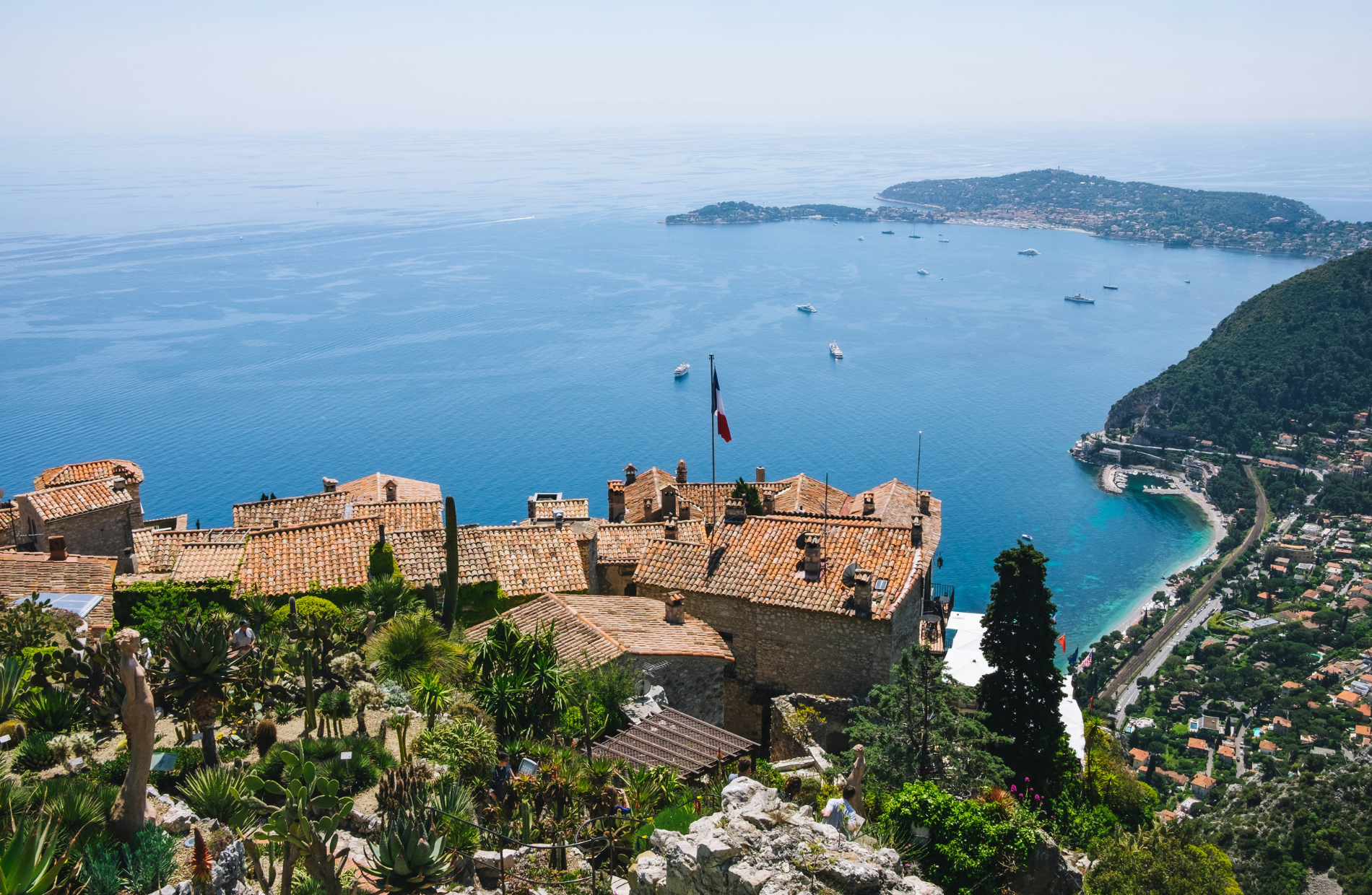A castle overlooking a body of water surrounded by trees
