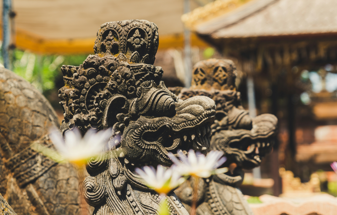 two decorative lion sculptures at an Indonesian temple