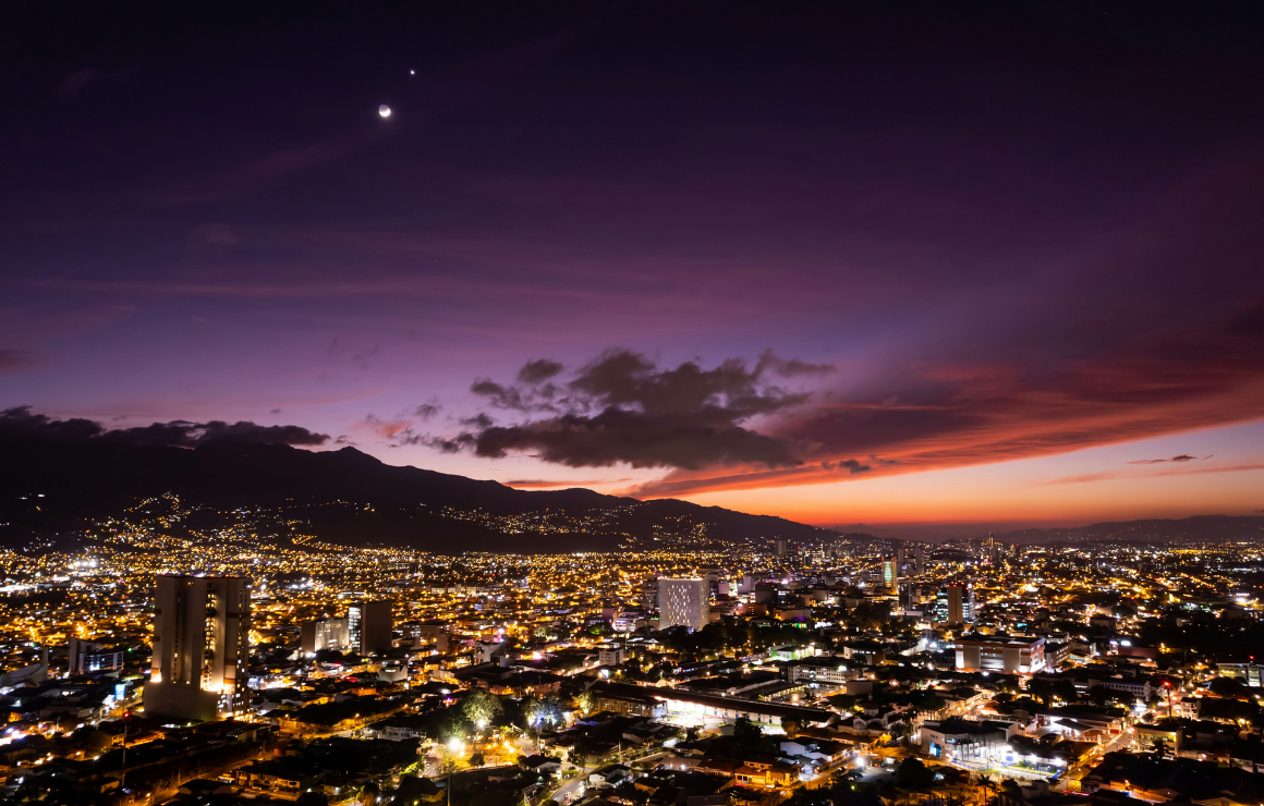 Sunset view of San Jose Costa Rica's city scape with mountains in the background