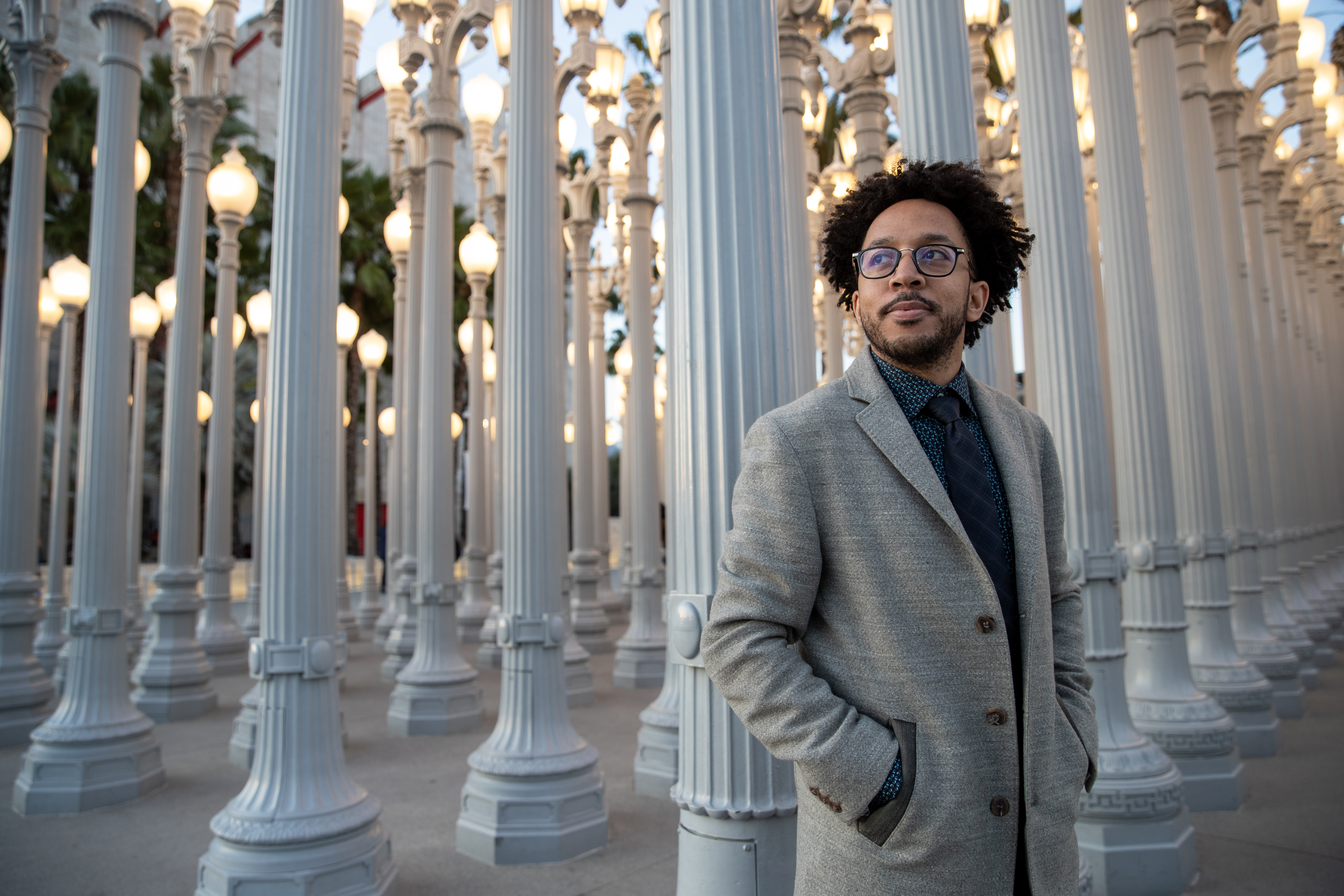 Archie Roundtree posing in front of white pillars