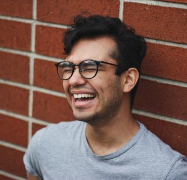 Photo of Adrian Alonzo Padilla in front of brick wall