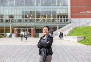 A woman standing in front of a library